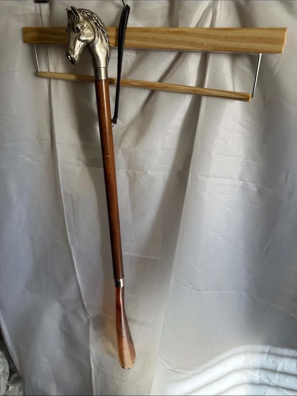Decorative shoe horn made in Italy. Horse head/metal, wooden shaft, plastic.